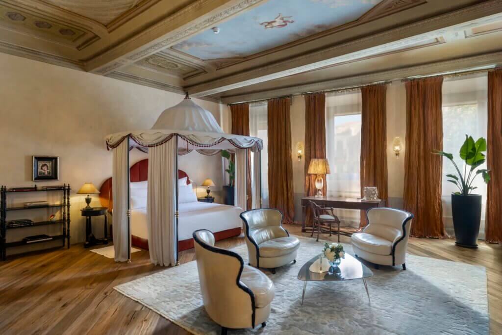Luxury suite at The James Hotel, Florence, featuring a 19th-century pavilion-inspired canopy bed, frescoed ceiling, and refined Italian interior design.