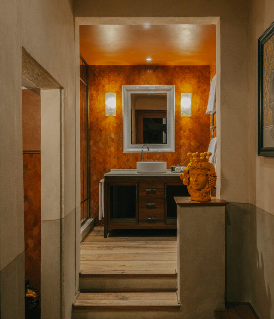 Luxury bathroom at The James Hotel, Florence, featuring handmade orange tiles, Italian craftsmanship, and a Marrakesh-inspired design aesthetic.